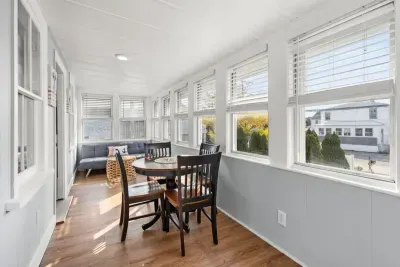Three-seasons porch with futon and table