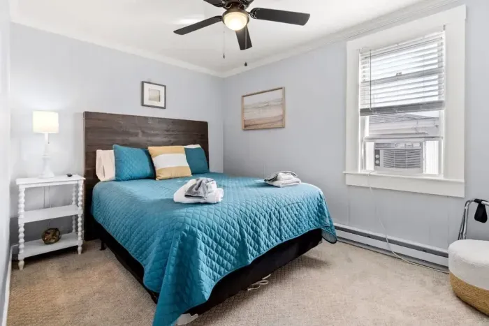 Bedroom #1 with queen bed, and mounted flatscreen smart Roku TV