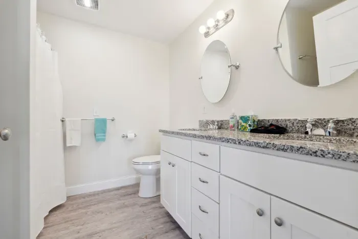 Ensuite bathroom with double vanity, standing shower, and in-unit washer dryer. Clean towels provided!