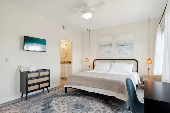 Master bedroom with king bed, Roku smart TV, desk, and ensuite bathroom