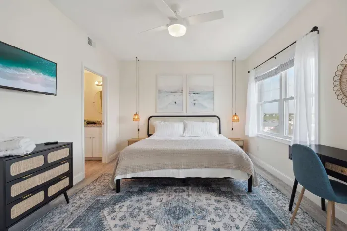 Master bedroom with king bed, Roku smart TV, desk, and ensuite bathroom. Clean linens provided!
