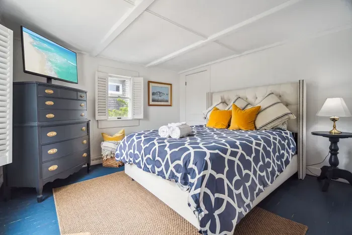 The third bedroom, located at the back corner of the home. This room has a smart TV and a queen bed with clean provided linens.