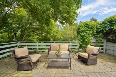 Plenty of seating on the upper patio to relax after a day at the beach! Enjoy the hydrangeas and the glow of the warm evening sun