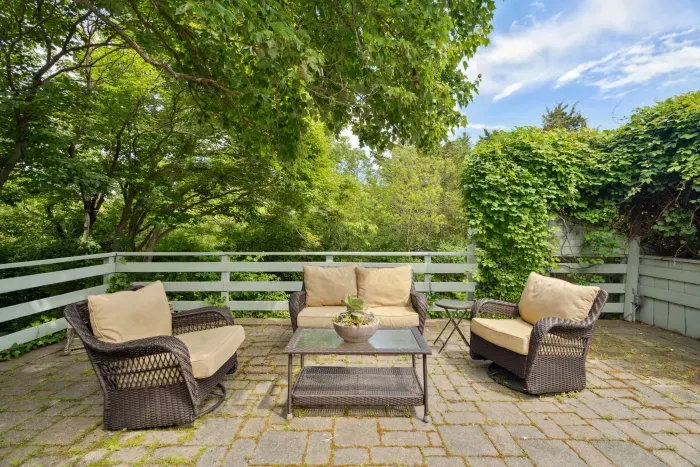 Plenty of seating on the upper patio to relax after a day at the beach! Enjoy the hydrangeas and the glow of the warm evening sun