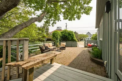 Plenty of seating on the upper patio to relax after a day at the beach! Enjoy the hydrangeas and the glow of the warm evening sun