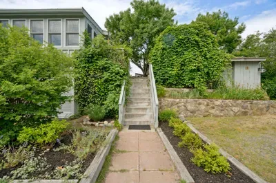 The main entry to the home has about 12 steps up to the home. Please be prepared as these steps are relatively steep. There is another driveway on the right where there are only 2 steps. Parking for 4 vehicles in the driveway