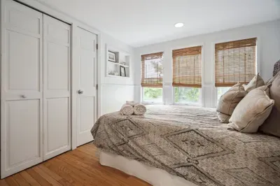 The second bedroom, with a seagrass theme and a queen bed. Clean linens provided. The washer and dryer are located in this closet.