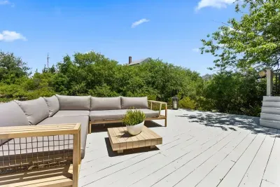 Lounge on the lower deck surrounded by Plum island old growth trees