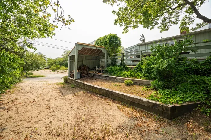 The alterntive access to the home is via this flat sandy path up to the 2 granite steps up to the main level of the deck.