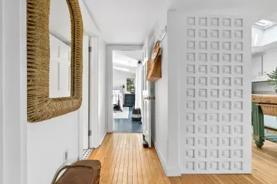 Off the kitchen is the main bathroom, and the secluded primary suite