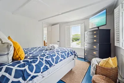 The third bedroom, located at the back corner of the home. This room has a smart TV and a queen bed with clean provided linens.
