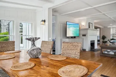 Step into the coastal dining area with seagrass chairs and tons of natural light provided by a surround of windows!