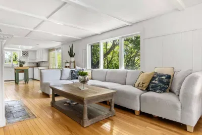 Walk into the living area which is filled with natural light and plenty of seating! This room has a large smart TV and easy access to the patio and dining area