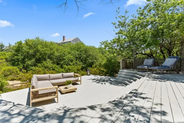 The deck area is huge with plenty of seating for all guests! There is a large sectional, lounge chairs, and a dining set. There is a gas grill as well!