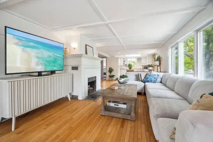 The living room has amazing natural light, a large sectional, and a large smart tv. Please note the fireplace is inoperable. 