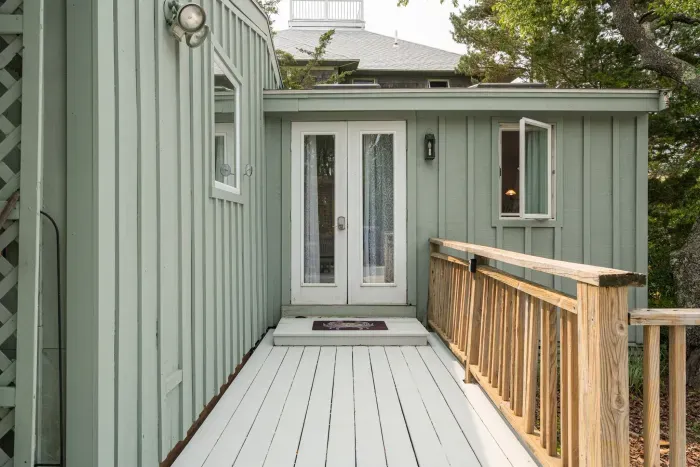 Alternative and direct access to the deck from the primary bedroom through these french doors! Main entryway is via the sliding door by the kitchen.