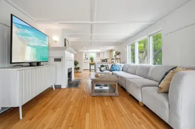 The living room has amazing natural light, a large sectional, and a large smart tv. Please note the fireplace is inoperable.