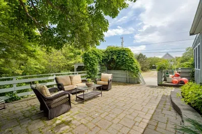 Plenty of seating on the upper patio to relax after a day at the beach! Enjoy the hydrangeas and the glow of the warm evening sun