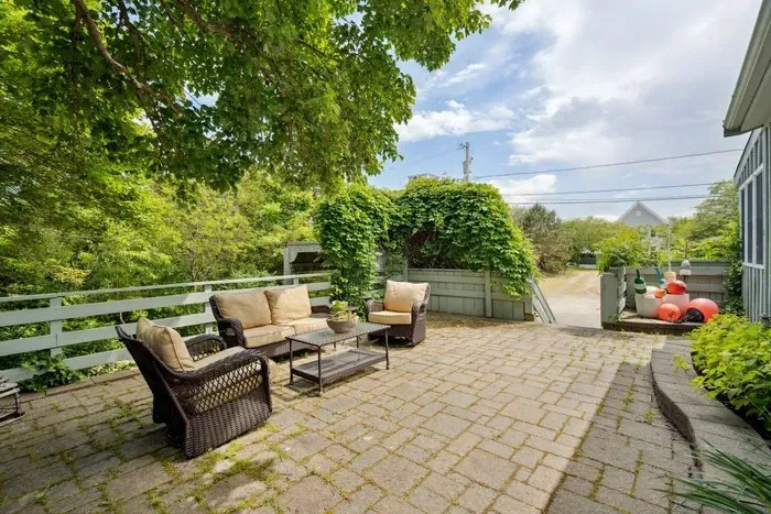 Plenty of seating on the upper patio to relax after a day at the beach! Enjoy the hydrangeas and the glow of the warm evening sun