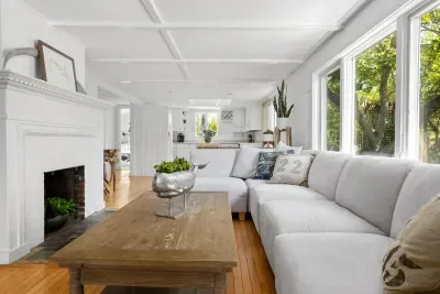 The living room has amazing natural light, a large sectional, and a large smart tv. Please note the fireplace is inoperable.