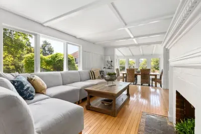 The living room has amazing natural light, a large sectional, and a large smart tv. Please note the fireplace is inoperable.