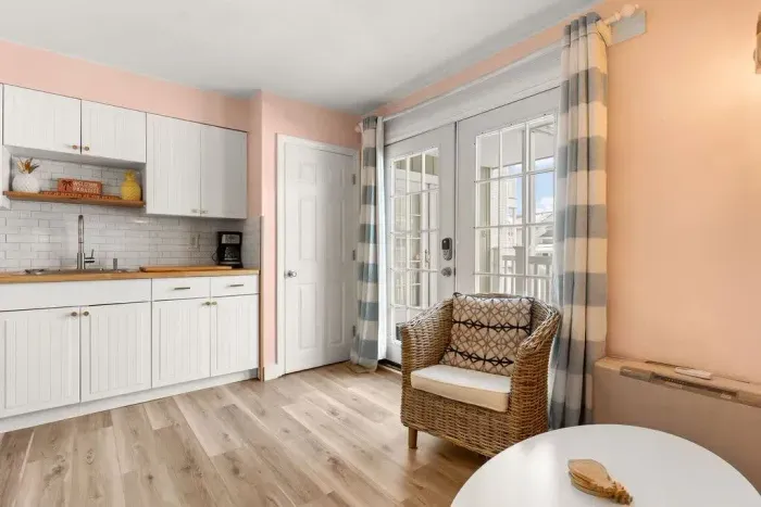 Newly renovated kitchen/living room with flatscreen smart TV, stove, refridgerator, microwave and sleeper sofa