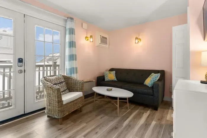 Newly renovated kitchen/living room with flatscreen smart TV, stove, refridgerator, microwave and sleeper sofa