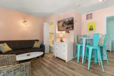 Newly renovated kitchen/living room with flatscreen smart TV, stove, refrigerator, microwave and sleeper sofa