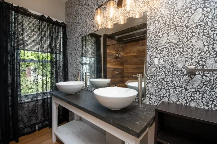 1st bedroom ensuite full bathroom with double vanity and provided hand soap, shampoo, body wash and towels