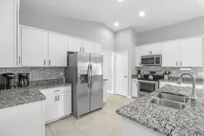 Fully equipped and stocked kitchen with all major appliances, kitchen table with 4 chairs and island with 4 stools.