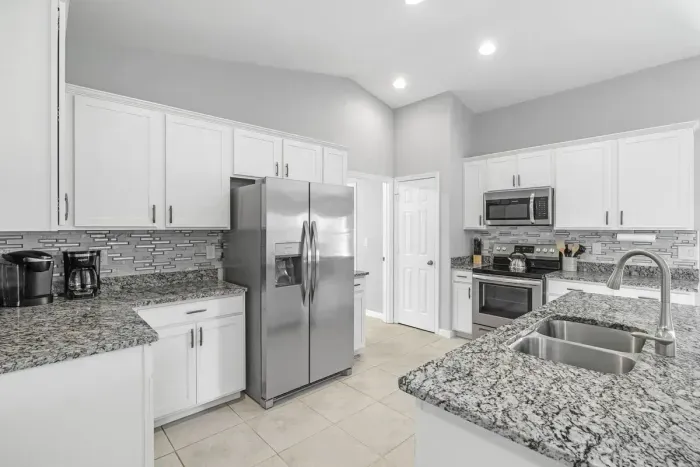 Fully equipped and stocked kitchen with all major appliances, kitchen table with 4 chairs and island with 4 stools.