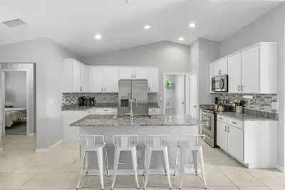 Fully equipped and stocked kitchen with all major appliances, kitchen table with 4 chairs and island with 4 stools.