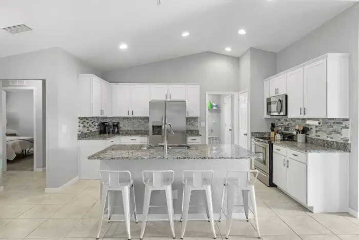 Fully equipped and stocked kitchen with all major appliances, kitchen table with 4 chairs and island with 4 stools.