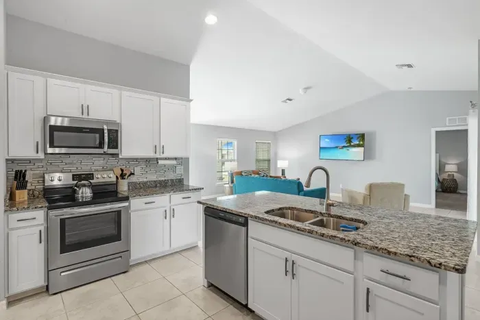 Fully equipped and stocked kitchen with all major appliances, kitchen table with 4 chairs and island with 4 stools.