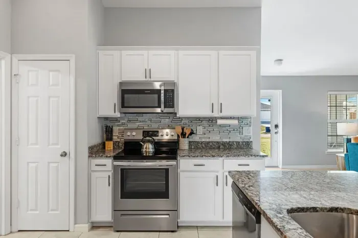 Fully equipped and stocked kitchen with all major appliances, kitchen table with 4 chairs and island with 4 stools.