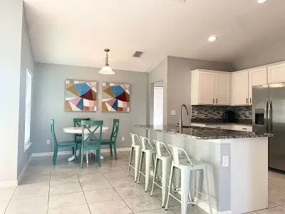 Fully equipped and stocked kitchen with all major appliances, kitchen table with 4 chairs and island with 4 stools.