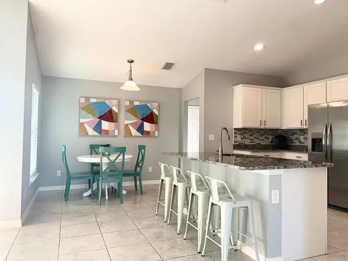 Fully equipped and stocked kitchen with all major appliances, kitchen table with 4 chairs and island with 4 stools.