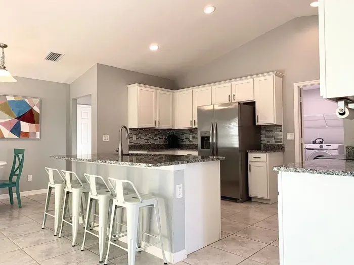 Fully equipped and stocked kitchen with all major appliances, kitchen table with 4 chairs and island with 4 stools.
