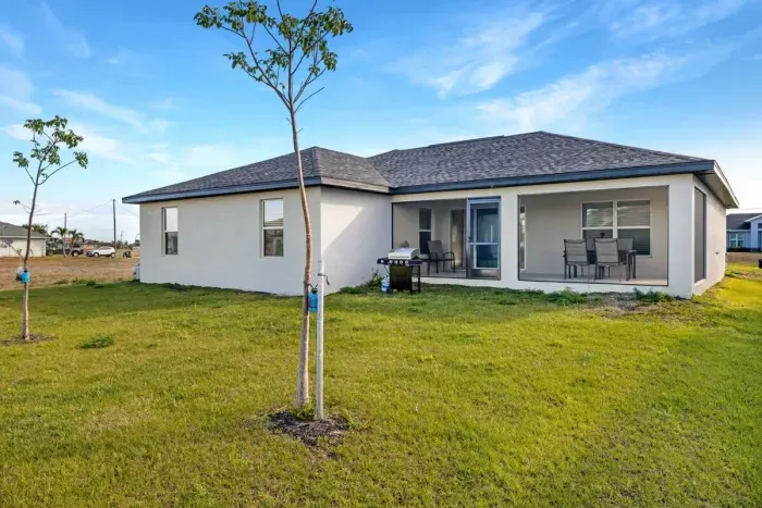 Screened-in Lanai, outdoor dining table, and plenty of outdoor space in both the front and back of out home. (Gas grill no longer on property)