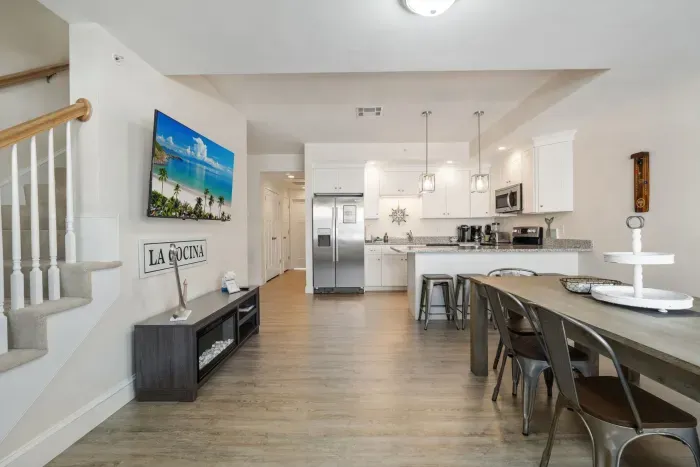 Dining room and kitchen with large smart TV