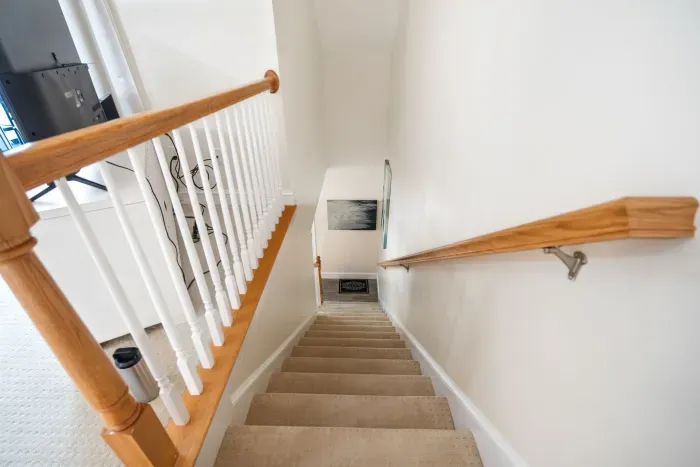 The stairs down to the first floor of the condo