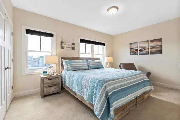 Primary bedroom with king bed, smart TV and provided linens