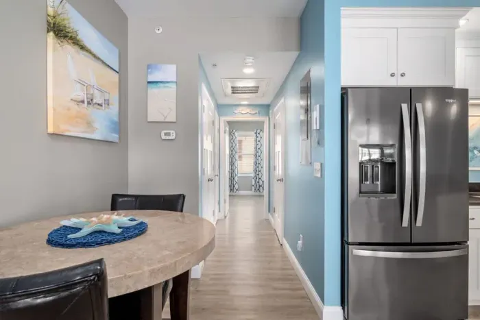 Open living room & kitchen with sleeper sofa, mounted smart TV, strong WiFi and fully-equipped kitchen