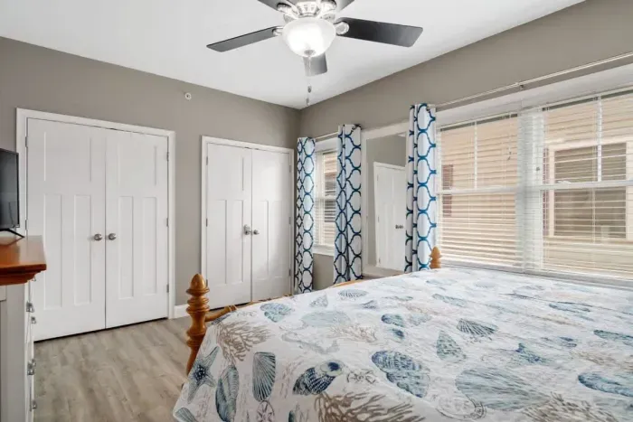 bedroom with ensuite bathroom with double sink, stand up shower and stackable washer & dryer