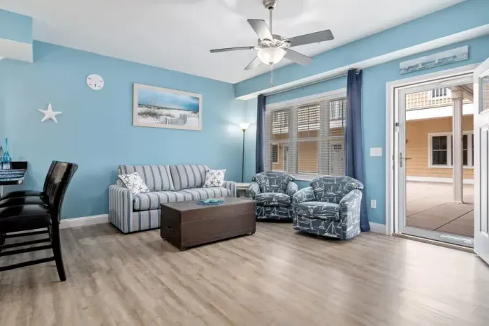 Open living room & kitchen with sleeper sofa, mounted smart TV, strong WiFi and fully-equipped kitchen