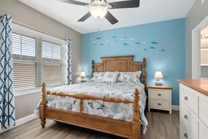 bedroom with ensuite bathroom with double sink, stand up shower and stackable washer & dryer