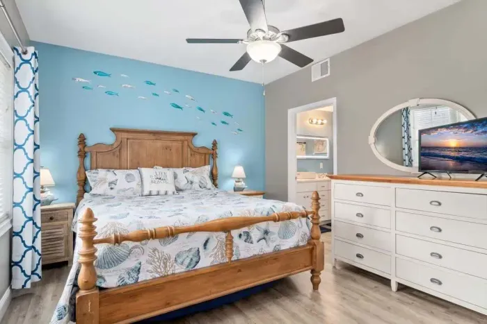 bedroom with ensuite bathroom with double sink, stand up shower and stackable washer & dryer