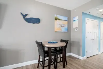 Open living room & kitchen with sleeper sofa, mounted smart TV, strong WiFi and fully-equipped kitchen