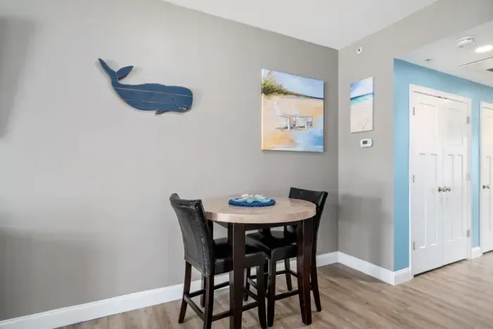 Open living room & kitchen with sleeper sofa, mounted smart TV, strong WiFi and fully-equipped kitchen