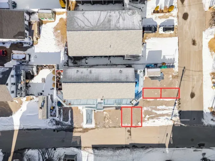 Aerial view of the home and its 4 parking spaces. Two are side-by-side and the other two are front to back. Larger SUVs/trucks may need the entire back to back space